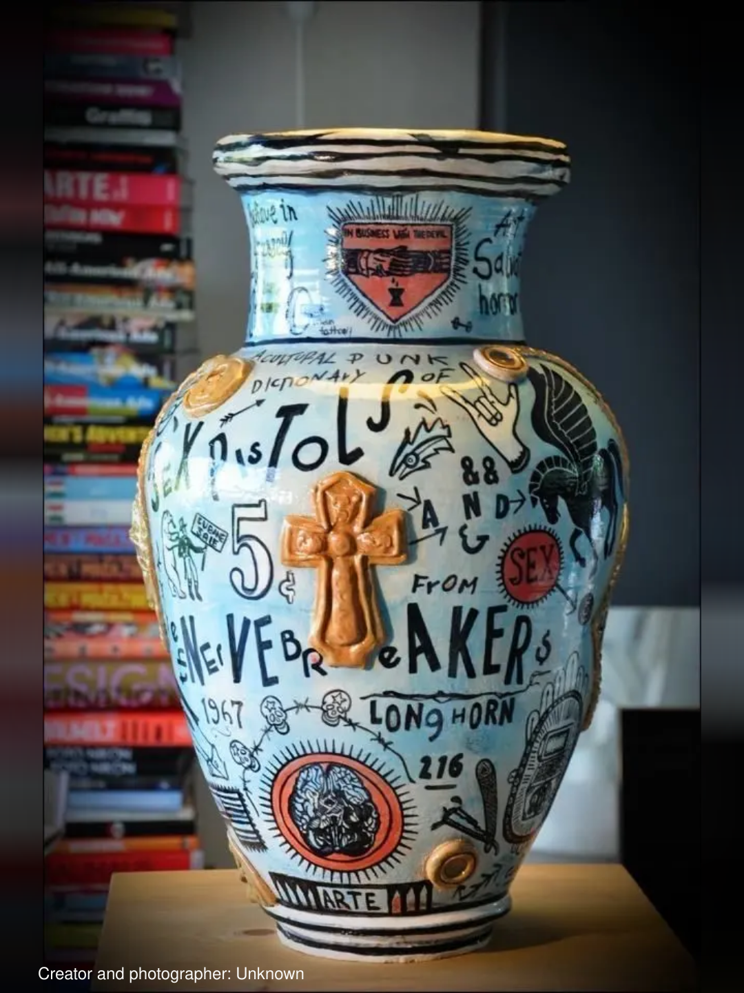 Text-covered vase with gold cross